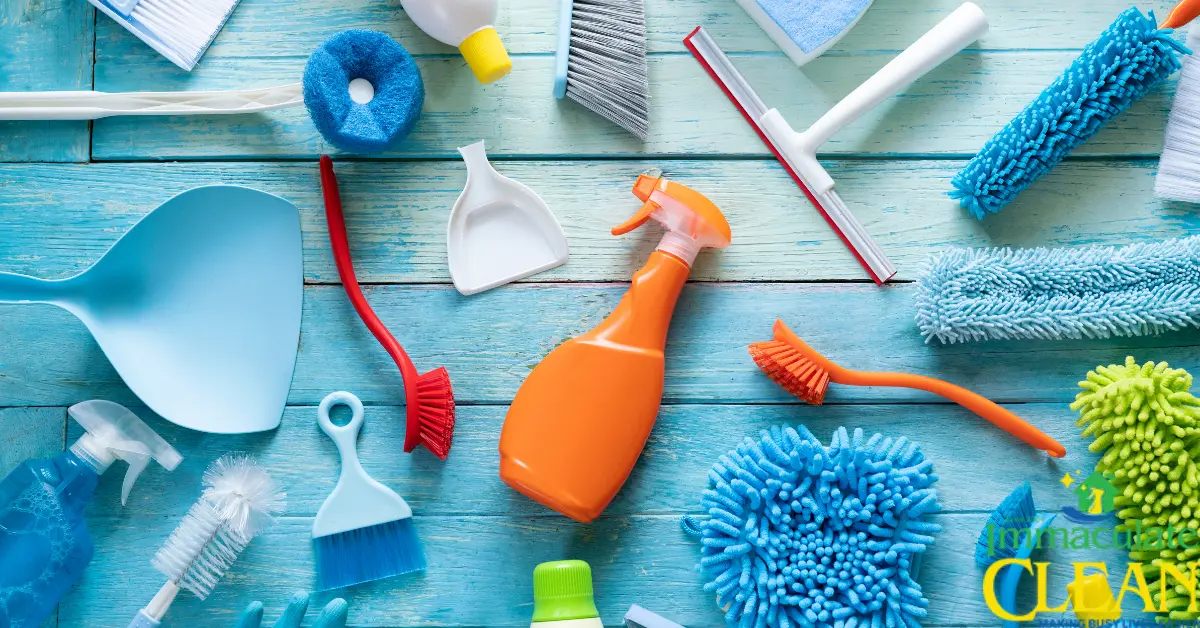 A variety of cleaning supplies on a blue wooden surface. | Immaculate Clean