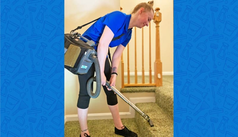 Service Rep Cleaning The Carpet With A Vacuum Cleaner