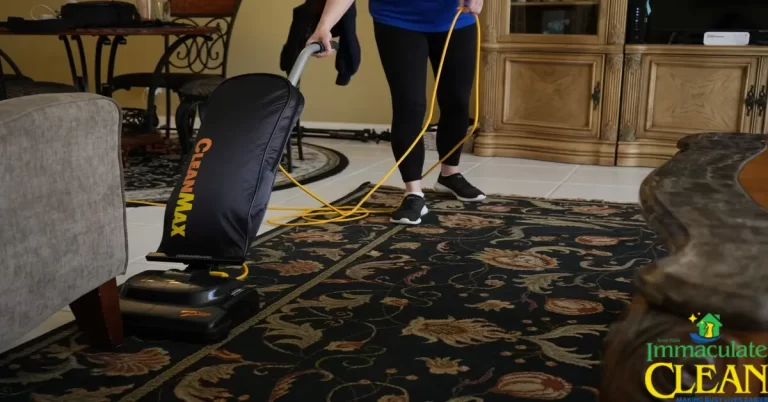 A woman cleaning a carpet with a vacuum cleaner | IC